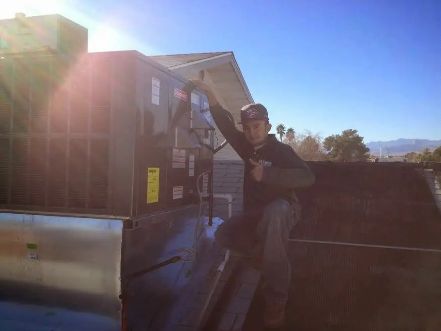 HVAC technician performing AC Tune-Up on a rooftop unit in Haysville